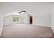 Finished bonus room with carpet, natural light, and access to additional space at 7103 Forest Ridge Rd, Matthews, NC 28104