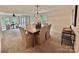 Elegant dining room with a chandelier, large windows, and seating for six at 7103 Forest Ridge Rd, Matthews, NC 28104