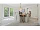 Bright dining area with large windows, stylish chandelier, and seating for six at 7103 Forest Ridge Rd, Matthews, NC 28104