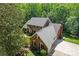 Aerial view of a stately brick home with a well manicured lawn and mature trees at 7103 Forest Ridge Rd, Matthews, NC 28104