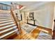 Spacious foyer with hardwood floors, staircase, and neutral decor, creating a welcoming entrance at 7103 Forest Ridge Rd, Matthews, NC 28104