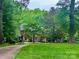 Beautiful brick home with mature trees and a well-manicured lawn offering great curb appeal at 7103 Forest Ridge Rd, Matthews, NC 28104