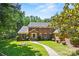 Stately brick home with a symmetrical facade, manicured lawn, and a welcoming front entrance at 7103 Forest Ridge Rd, Matthews, NC 28104