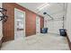 Clean and spacious three car garage with brick accents, overhead doors, and storage at 7103 Forest Ridge Rd, Matthews, NC 28104