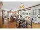 Eat-in kitchen featuring warm wood cabinetry, a breakfast bar, and access to a sunroom at 7103 Forest Ridge Rd, Matthews, NC 28104