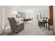 Comfortable living room with plush seating, a well-lit desk area, and neutral color palette at 7103 Forest Ridge Rd, Matthews, NC 28104
