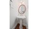 Charming powder room with pedestal sink and wood-framed mirror at 7103 Forest Ridge Rd, Matthews, NC 28104
