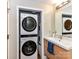 Bathroom featuring a stacked washer and dryer unit along with a full vanity at 715 N Church St # 213, Charlotte, NC 28202