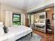 Bright bedroom with large windows, hardwood floors, and a mirrored closet at 715 N Church St # 213, Charlotte, NC 28202