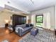 Bright living room featuring a large window with natural light, modern decor, and a stylish gray sofa and ottoman at 715 N Church St # 213, Charlotte, NC 28202