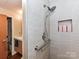 Tiled shower with modern fixtures and recessed niche for storage at 715 N Church St # 213, Charlotte, NC 28202