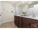 Bathroom with double vanity, light fixtures and mirror. Large window providing natural light at 7341 Adare Mews Rd, Charlotte, NC 28217