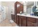 Bathroom features dark wood cabinets, tile flooring and a large mirror with modern fixtures at 7341 Adare Mews Rd, Charlotte, NC 28217