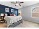 Bedroom with a ceiling fan, a large window, and a plush bed with decorative pillows at 7341 Adare Mews Rd, Charlotte, NC 28217