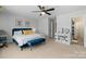 Comfortable bedroom with a navy bed, ceiling fan and extra storage at 7341 Adare Mews Rd, Charlotte, NC 28217