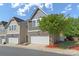 Charming townhome featuring a two-car garage and beautiful stone accents on the facade at 7341 Adare Mews Rd, Charlotte, NC 28217