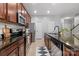 Kitchen boasts stainless appliances, granite countertops, and stylish cabinets at 7341 Adare Mews Rd, Charlotte, NC 28217