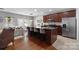 The kitchen features a large island, modern appliances, and bar stool seating, and is open to the living area at 7341 Adare Mews Rd, Charlotte, NC 28217