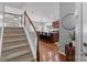 View of the stairway leading to the kitchen with an island and barstool seating at 7341 Adare Mews Rd, Charlotte, NC 28217