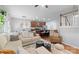 Spacious living room with a sectional sofa, open to a kitchen with dark cabinets at 7341 Adare Mews Rd, Charlotte, NC 28217