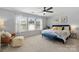 Spacious main bedroom featuring large windows, a ceiling fan and neutral tones at 7341 Adare Mews Rd, Charlotte, NC 28217