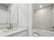 Bathroom featuring a modern vanity, and a shower-over-tub combo with tiled walls at 9948 Manor Vista Trl, Kannapolis, NC 28027