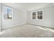 Light-filled bedroom with plush carpeting and multiple windows offering ample natural light at 9948 Manor Vista Trl, Kannapolis, NC 28027
