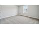 Cozy bedroom with a sunlit window and neutral carpeting at 9948 Manor Vista Trl, Kannapolis, NC 28027