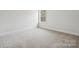 Light-filled bedroom with neutral carpeting, bright window, and neutral paint at 9948 Manor Vista Trl, Kannapolis, NC 28027