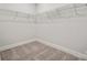 Walk-in closet featuring carpeted floors, base trim and wire shelving for ample storage at 9948 Manor Vista Trl, Kannapolis, NC 28027