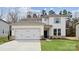 Charming two-story home with a two-car garage, manicured lawn, and classic architectural details at 9948 Manor Vista Trl, Kannapolis, NC 28027