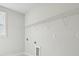Spacious laundry room features a large shelving rack, utility connections, and natural light at 9948 Manor Vista Trl, Kannapolis, NC 28027