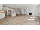 Spacious living area with wood floors, modern fireplace and an open view to the kitchen at 9948 Manor Vista Trl, Kannapolis, NC 28027