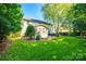 Lush backyard featuring a screened porch, patio, and expansive lawn, ideal for outdoor entertaining and relaxation at 1020 Forbishire Dr, Matthews, NC 28104