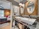 Stylish bathroom with double sinks, decorative mirrors, modern fixtures, and updated tiling at 1020 Forbishire Dr, Matthews, NC 28104