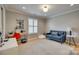 Comfortable bedroom with light hardwood floors, a blue sofa, a desk, and bright natural light at 1020 Forbishire Dr, Matthews, NC 28104