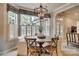 Cozy breakfast nook with a round wooden table, white chairs, and lots of natural light at 1020 Forbishire Dr, Matthews, NC 28104