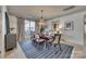 Elegant dining room with modern decor, a stylish chandelier, and a view of the outdoors at 1020 Forbishire Dr, Matthews, NC 28104