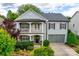 Charming two-story home with a covered porch, balcony, manicured landscaping, and an attached two-car garage at 1020 Forbishire Dr, Matthews, NC 28104