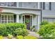 Close-up of a beautiful front door with sidelights, a wreath, and lush landscaping at 1020 Forbishire Dr, Matthews, NC 28104