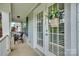 Inviting front porch with seating, floral decor, and elegant front door at 1020 Forbishire Dr, Matthews, NC 28104