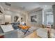 Cozy living room features built-in media center, large area rug, hardwood floors, and stylish gray sofa and ottoman at 1020 Forbishire Dr, Matthews, NC 28104