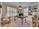 Bright home office featuring built-in bookshelves, a large desk, and a comfortable seating area at 1020 Forbishire Dr, Matthews, NC 28104