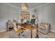 Well-lit home office space with a desk, shelving, and neutral decor, open to other living spaces at 1020 Forbishire Dr, Matthews, NC 28104