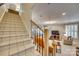 Carpeted staircase leading to a bright living area with a fireplace and comfortable seating at 1020 Forbishire Dr, Matthews, NC 28104