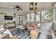 Relaxing sunroom with wicker seating, ceiling fan, and access to the patio at 1020 Forbishire Dr, Matthews, NC 28104