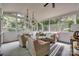 Bright sunroom with wicker furniture, hanging lanterns, and views of the yard at 1020 Forbishire Dr, Matthews, NC 28104