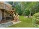 Beautiful backyard featuring a staircase to a deck with an outdoor sitting area around a fire pit at 104 Whiterock Dr, Mount Holly, NC 28120