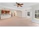 Spacious finished basement featuring a wet bar, staircase, ceiling fan, and natural light at 104 Whiterock Dr, Mount Holly, NC 28120