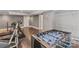 Finished basement includes workout area, foosball table, and white shelving for ample storage at 104 Whiterock Dr, Mount Holly, NC 28120